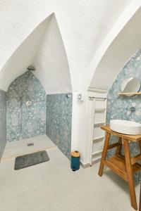 an attic bathroom with a sink and a shower at Romantic Suite in Gallipoli