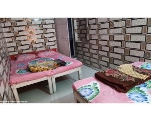 a room with two beds and a table with bananas on it at Hotel Jagatguru, Barkot in Barkot