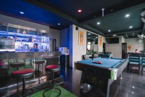 a billiard room with a bar and a pool table at Noble House Patong in Patong Beach