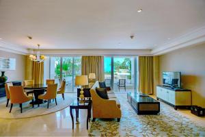 a living room with a table and a dining room at Sheraton Haikou Hotel in Haikou