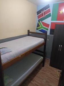 ein kleines Schlafzimmer mit einem Etagenbett und einem Regal in der Unterkunft Hostel Morais Praia in Maceió