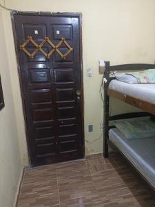 a door in a room with two bunk beds at Hostel Morais Praia in Maceió