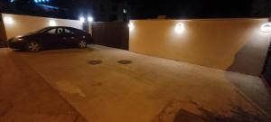 a car parked in a parking lot at night at Tiny Village Mamaia Nord - House 1 in Mamaia Sat/Năvodari