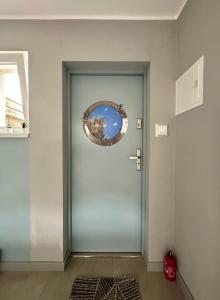 a blue door with a wreath on it at Złota Rybka in Rewa