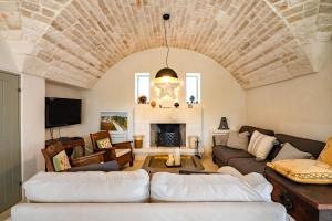 sala de estar con 2 sofás y chimenea en Trullo Nostress with pool, en Ceglie Messapica