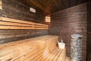 an empty sauna with wooden walls and a wooden floor at Stodoły Słona Zatoka in Władysławowo +22 photos