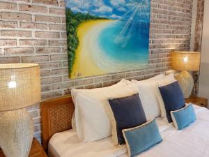 a bedroom with a brick wall and a bed with pillows at Spaces Bali Unique Boutique Hotel in Munggu