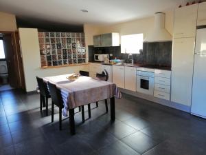 a kitchen with a table and chairs in a kitchen at La Pallissa 9 in Torroella de Montgrí