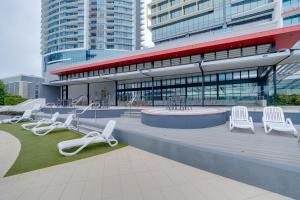 a building with white chairs and tables and buildings at Ocean Views Apartment in Southport Central in Gold Coast