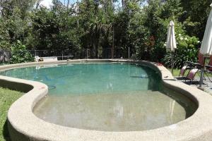 a swimming pool in the middle of a yard at Family Friendly in Howard Springs