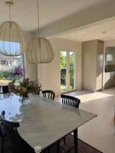 a dining room with a large table and chairs at Villa nära till natur och stan in Gothenburg