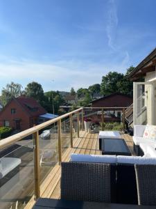 a deck with chairs and tables on a house at Villa nära till natur och stan in Gothenburg