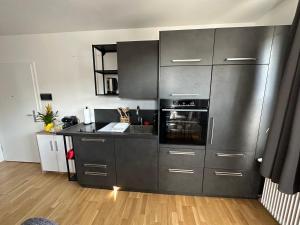 a kitchen with stainless steel appliances and wooden floors at Urlaub in Schlossnähe in Artstetten