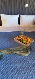 a tray of fruit on the floor of a hotel room at Vice Versa Elegant Studio 1 in Nafplio