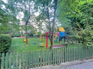 a playground in a park with a fence at Your Apart Saska Kępa in Warsaw