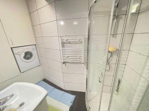 a bathroom with a shower and a sink and a toilet at Your Apart Saska Kępa in Warsaw