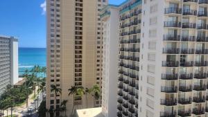 an aerial view of two tall buildings and the ocean at Waikiki Condo 2 Bedrooms 2 Bathrooms with 1 free parking space in Honolulu