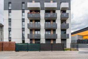 a building with balconies on the side of it at Apartments with Garden Dmowskiego 81 by Renters in Poznań