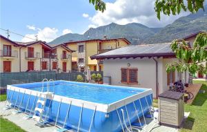 a large swimming pool in a yard with buildings at La Gallina in Artogne