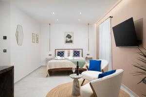 a living room with a bed and two chairs at Twins Amphitheatre Apartments in Pula
