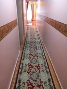 a hallway with a rug on the floor of a house at Apartment Close to the sea in Alexandria