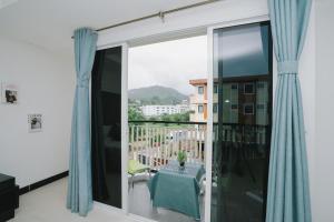 a balcony with a table and a view of a city at Noble House Patong in Patong Beach