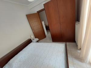 an empty room with a bed and a closet at KLEOPATRA APARTMENT in Neoi Epivates