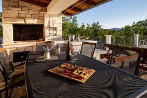 a plate of food on a table on a patio at Villa Menalo in Neum