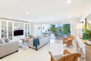 a living room with a couch and a table at Kiama Waterfront Apartment in Kiama