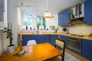 eine Küche mit blauen Schränken und einem Holztisch in der Unterkunft Casa Wimpina - geschmackvolles Appartement im Herzen der Altstadt in Bad Wimpfen