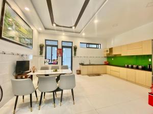 una cucina con un tavolo e sedie in una stanza di Home Stay Ruby Nha Trang a Nha Trang
