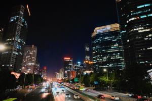 a city skyline at night with cars on a freeway at JW Marriott Hotel Beijing in Beijing
