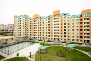a large building with a park in front of it at VIP апартамент in Sumqayyt