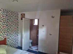 a bedroom with a door to a bathroom with a toilet at Vila Ioana & Mirel in Eforie Sud +24 photos