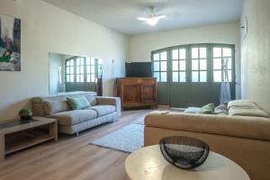 een woonkamer met een bank en een tafel bij Bas de villa- Bastide zebra in Contes