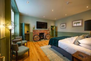 a bedroom with a bed and a fireplace and a television at The Lodge in Hunstanton