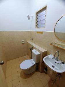 a bathroom with a toilet and a sink at Tenang Retreat Holiday Home in Kajang