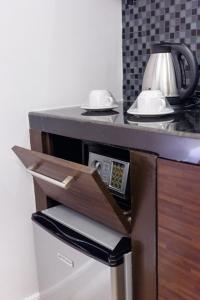 a drawer in a counter with a microwave at NEST NANO SUITES POBLACION-MAKATI in Manila