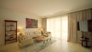 uma sala de estar com um sofá e uma televisão em Lustica Bay Apartment Honey By 2bhome em Radovići