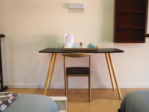 a table in a room with a chair next to it at papaya resort in Kampung Tekek