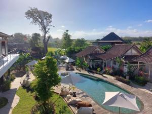 an aerial view of a resort with a swimming pool at Spaces Bali Unique Boutique Hotel in Munggu