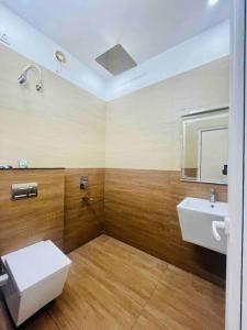 a bathroom with a white toilet and a sink at Second home International airport T-1 in Trivandrum