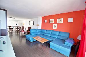 een woonkamer met een blauwe bank en een tafel bij Lighthouse Altea in Altea +19 foto's