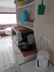 una cucina con macchinetta del caffè su un bancone di Marennes mobilhome 46 Domaine des pins a Marennes