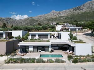 an aerial view of a house with a swimming pool at Villa Dimi private pool, sea view & 3 bedrooms in Paleros