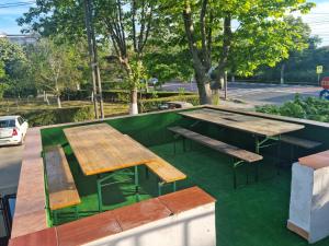 a picnic table and benches in a park at Vila Ioana & Mirel in Eforie Sud