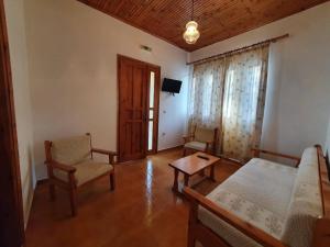 a living room with a bed and a table and chairs at Vigla Village in Spartià