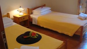 a hat on a table in a room with two beds at Vigla Village in Spartià +41 photos