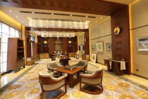 a lobby of a hotel with chairs and tables at Chengdu Tibetan Hotel in Chengdu