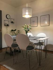 een eetkamer met een tafel en stoelen en een licht bij Fräsch centrumlägenhet! in Mariehamn